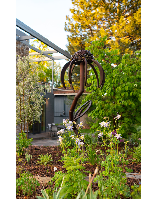 Garden sculpture of a purple coneflower